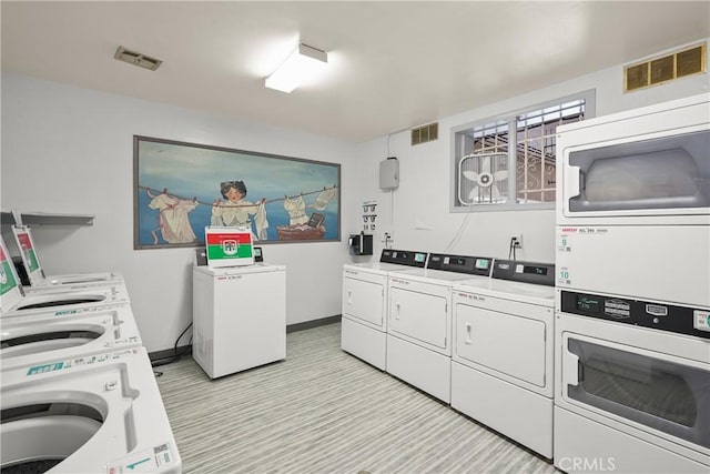 5845 Doverwood Dr Unit 216, Culver City, CA 90230 - kitchen with separate washer and dryer, stacked washer / drying machine, light countertops, and white cabinetry