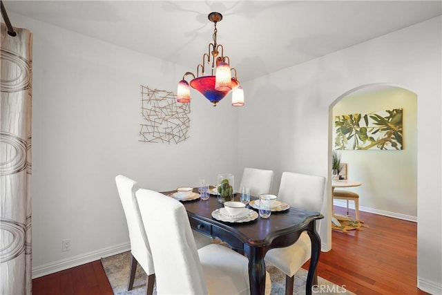 5845 Doverwood Dr Unit 216, Culver City, CA 90230 - dining area featuring hardwood / wood-style floors and arched walkways
