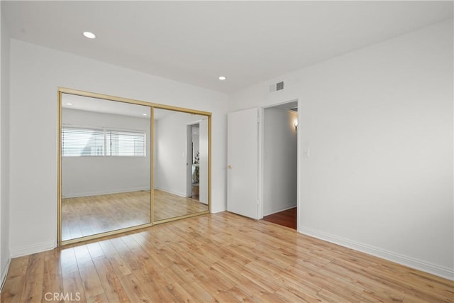 5845 Doverwood Dr Unit 216, Culver City, CA 90230 - unfurnished bedroom with light wood-style flooring, a closet, and recessed lighting