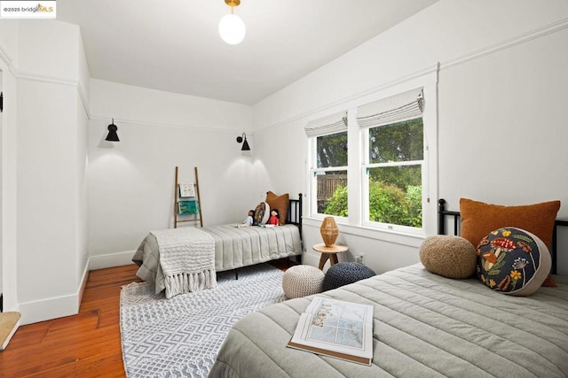 bedroom with hardwood / wood-style flooring