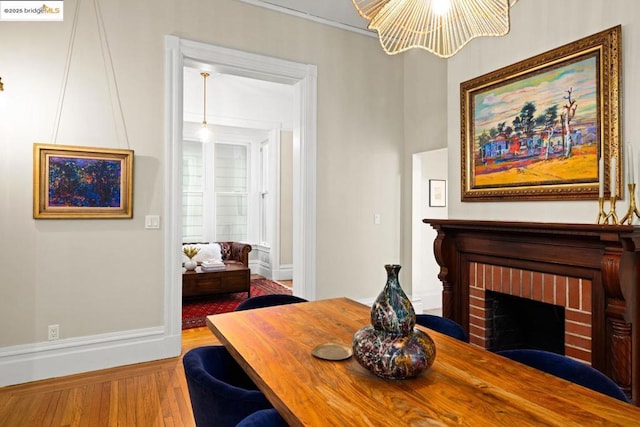 dining area featuring hardwood / wood-style floors and a fireplace