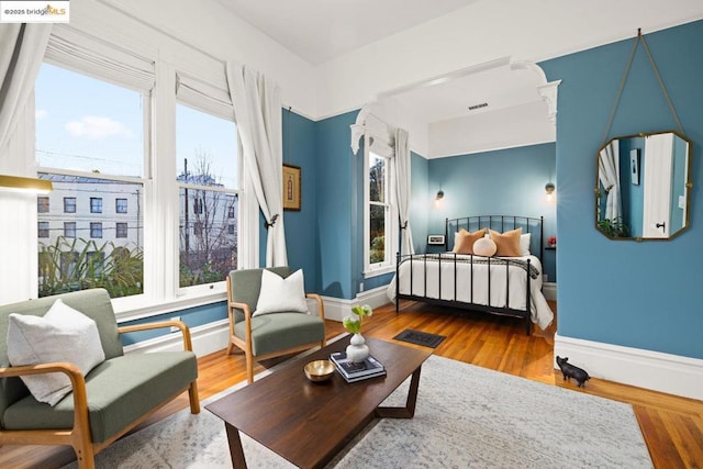 bedroom featuring multiple windows and wood-type flooring