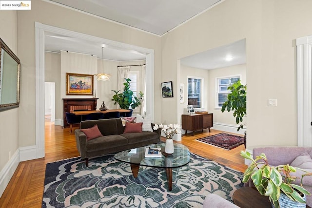 living room with wood-type flooring and crown molding