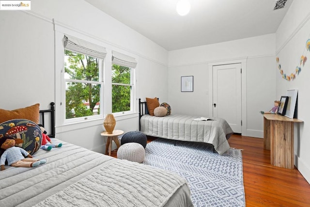 bedroom with hardwood / wood-style flooring