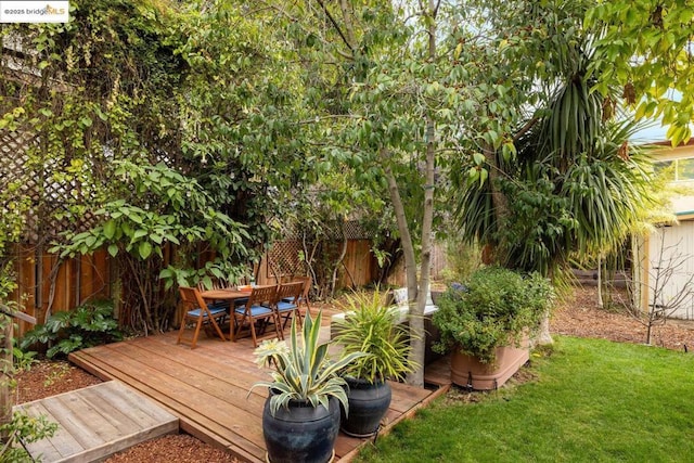 wooden terrace with a lawn