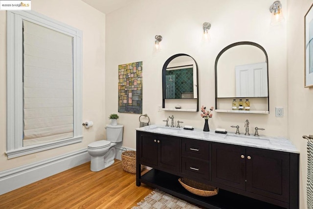 bathroom with hardwood / wood-style flooring, vanity, and toilet