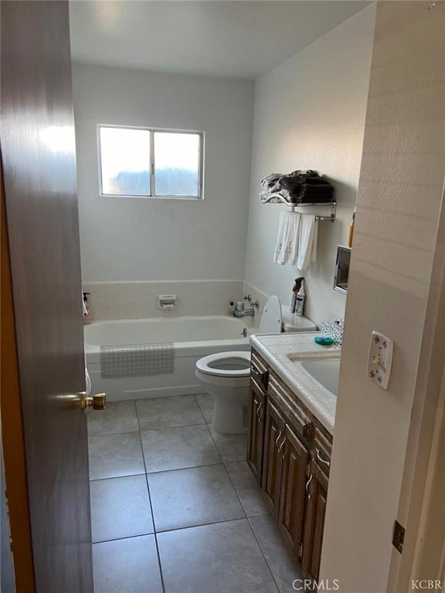 bathroom with vanity, tile patterned floors, a bathtub, and toilet