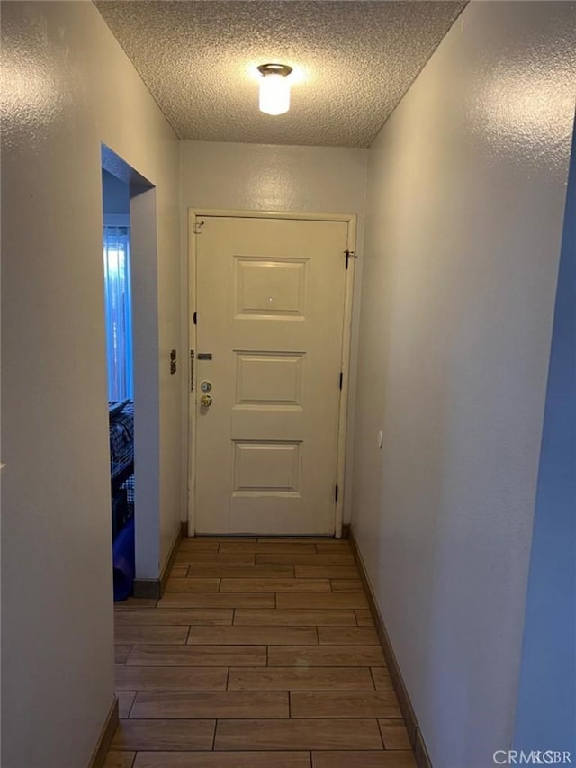 entryway with a textured ceiling