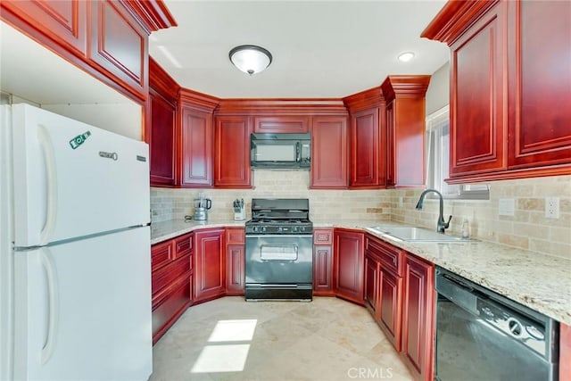 kitchen with light stone counters, backsplash, sink, and black appliances