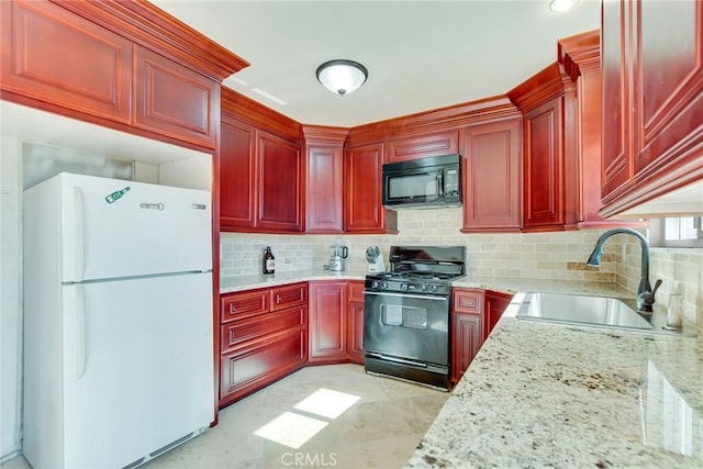 kitchen featuring tasteful backsplash, sink, light stone counters, and black appliances