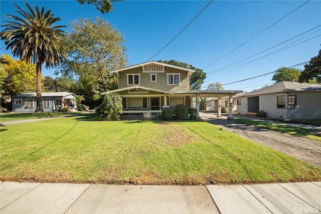 view of front facade with a front yard and a carport