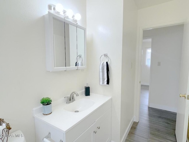 bathroom featuring hardwood / wood-style flooring, vanity, and toilet