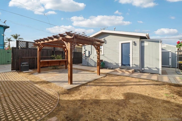 exterior space featuring a storage shed, a pergola, and a patio area