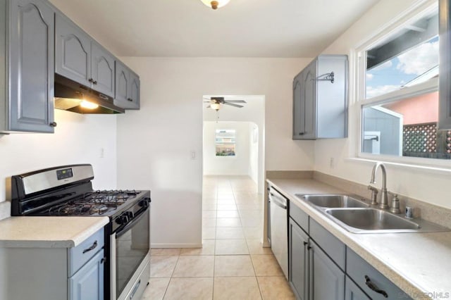 kitchen with a healthy amount of sunlight, sink, ceiling fan, and appliances with stainless steel finishes