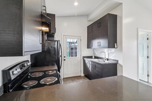 kitchen with sink, refrigerator, light hardwood / wood-style flooring, dark brown cabinets, and electric range