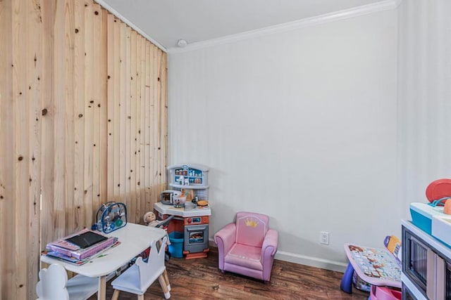 recreation room with crown molding and dark hardwood / wood-style flooring