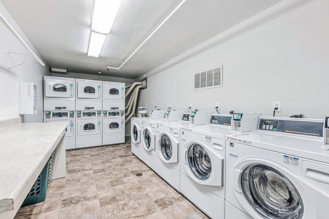 laundry area with stacked washing maching and dryer and washer and dryer