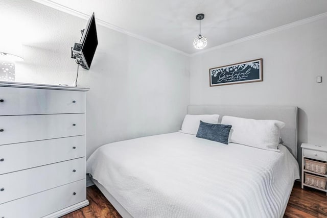 bedroom featuring crown molding and dark hardwood / wood-style floors