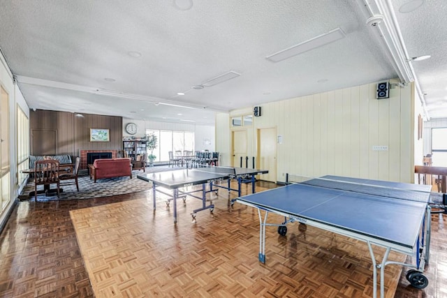 game room with a textured ceiling and light parquet floors