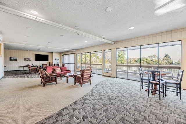 carpeted living room with a textured ceiling