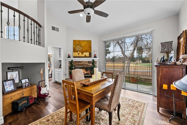 26800 Monet Ln, Valencia, CA 91355 - dining area with visible vents, lofted ceiling, ceiling fan, wood finished floors, and a stone fireplace