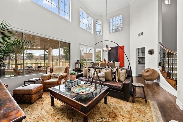 26800 Monet Ln, Valencia, CA 91355 - living area featuring visible vents, stairway, ornamental molding, wood finished floors, and a chandelier