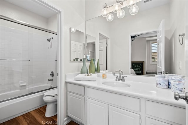 26800 Monet Ln, Valencia, CA 91355 - ensuite bathroom with connected bathroom, toilet, bath / shower combo with glass door, wood finished floors, and vanity