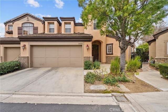 26800 Monet Ln, Valencia, CA 91355 - view of front of house with a garage, brick siding, driveway, and stucco siding