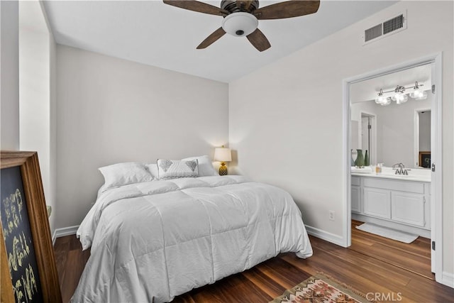 26800 Monet Ln, Valencia, CA 91355 - bedroom featuring baseboards, visible vents, dark wood-type flooring, ensuite bathroom, and a sink