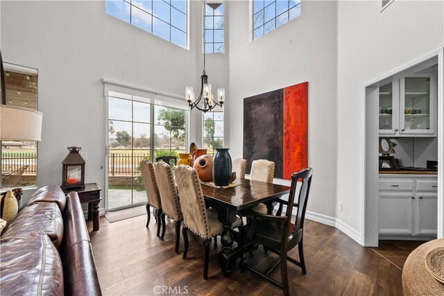 26800 Monet Ln, Valencia, CA 91355 - dining room featuring a towering ceiling, baseboards, a chandelier, and dark wood-style flooring