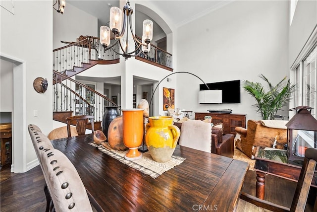 26800 Monet Ln, Valencia, CA 91355 - dining area featuring stairs, a high ceiling, dark wood finished floors, and an inviting chandelier