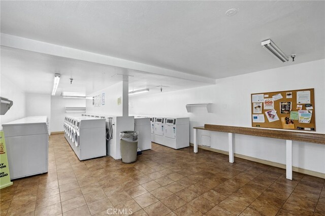 clothes washing area with washing machine and dryer