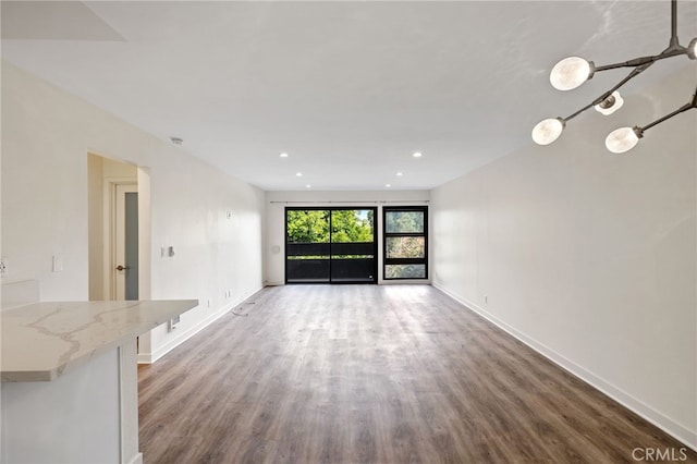 unfurnished living room featuring dark wood-type flooring