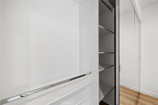 spacious closet featuring light hardwood / wood-style flooring