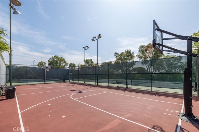 view of basketball court featuring tennis court