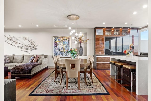 dining area featuring dark wood-type flooring and a chandelier