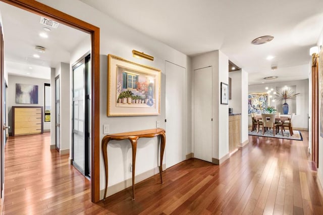 hall with hardwood / wood-style flooring