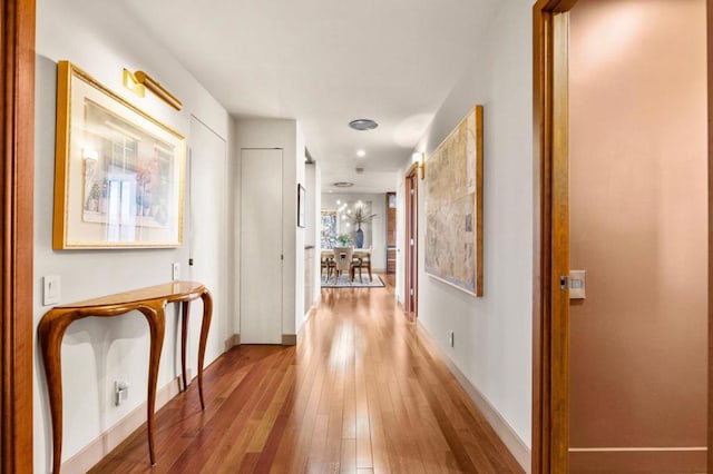 hallway with light hardwood / wood-style floors