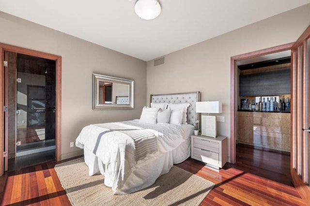 bedroom with dark hardwood / wood-style flooring