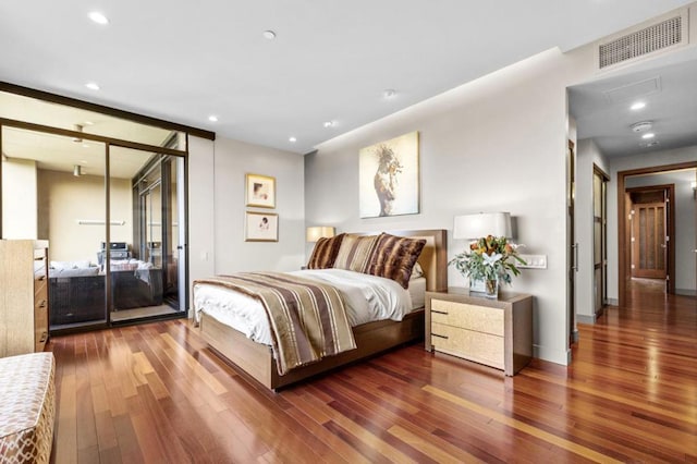 bedroom with dark hardwood / wood-style flooring and access to exterior