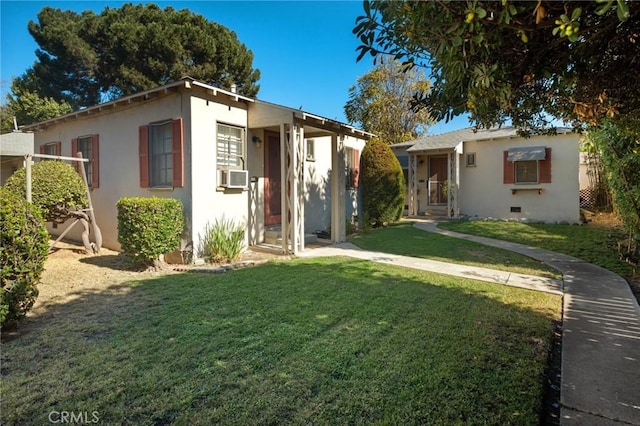 view of front of home featuring cooling unit and a front lawn