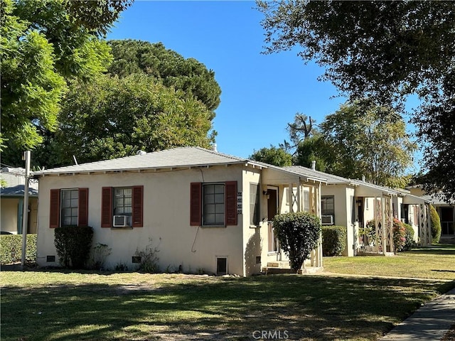 view of front of property with cooling unit and a front yard