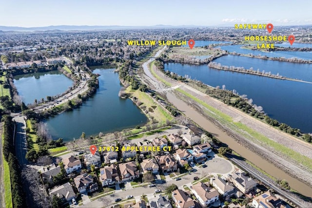 birds eye view of property with a water view