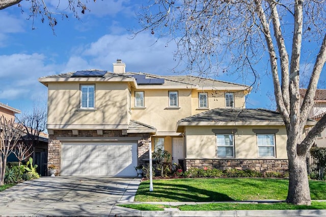 view of front facade with a garage, a front lawn, and solar panels