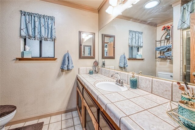 bathroom with vanity, tile patterned flooring, ornamental molding, and toilet