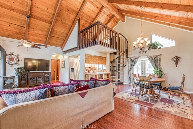 living room with hardwood / wood-style floors, beam ceiling, wooden ceiling, and a wood stove