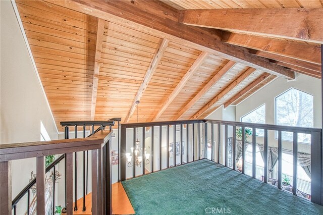 interior space featuring carpet, vaulted ceiling with beams, and wooden ceiling