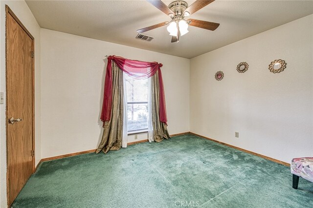 spare room featuring carpet flooring and ceiling fan