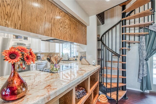 kitchen with dark wood-type flooring, appliances with stainless steel finishes, sink, and light stone counters