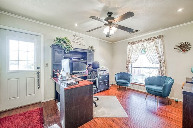 office featuring dark hardwood / wood-style flooring, a wealth of natural light, ornamental molding, and ceiling fan